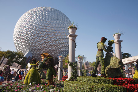 ORLANDO, USA - CIRCA 2009: Topiary Disney characters and the Spaceship Earth globe at the Epcot Center, Disneyworld, Orlando, Floridaのeditorial素材
