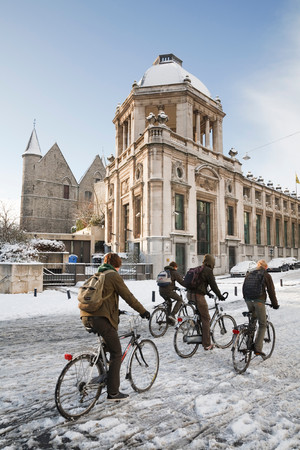 GHENT, BELGIUM - CIRCA 2010: School children cycling in winter through the streets of Ghent, Belgiumのeditorial素材