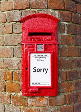 British post box with a message that reads Sorry, ideal for a greeting card designの写真素材