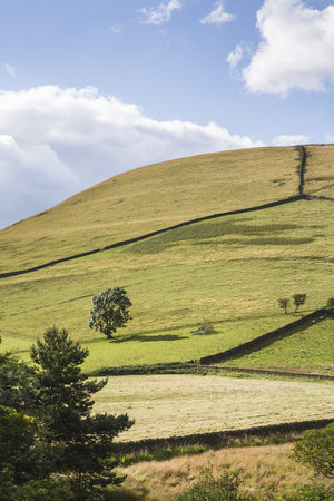 British countryside scene of hills and blue sky in Edale Valley, the Peak District, UKの写真素材