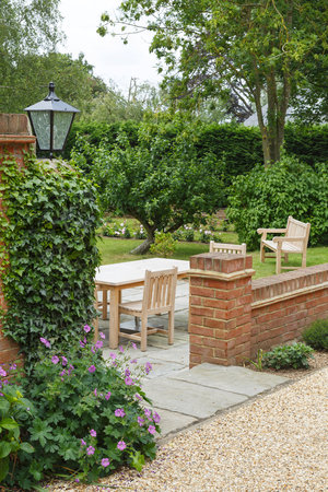 English UK garden in summer with patio and garden furnitureの写真素材