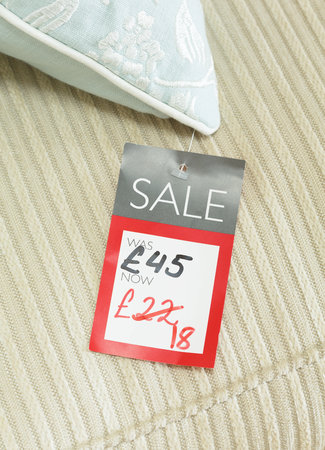 Mock-up of price tag showing reduced price of a discounted product for sale in a retail store. Priced in pounds sterling for UK marketの写真素材