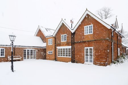 A traditional Victorian coach house covered in snow in winter. Buckingham, UKの写真素材