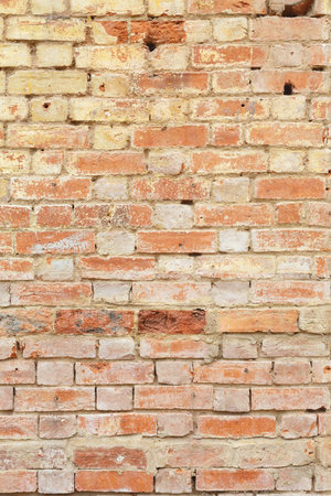 Detail of old brick wall, distressed and faded. Ideal for grunge background textureの写真素材