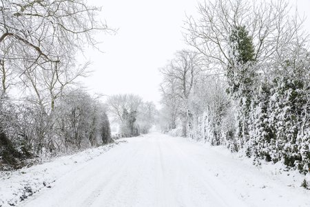 Snow covered road in English countryside in winter. Buckinghamshire, UKの写真素材