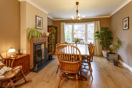 Traditional dining room interior with fireplace, wooden furniture, table and chairsの写真素材