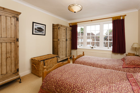 Bedroom with wooden furniture including antique pine wardrobesの写真素材