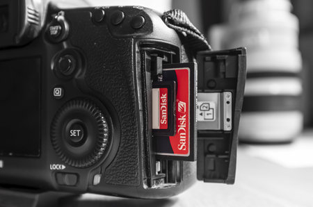UK - February 08, 2019. Sandisk SD and Compact Flash CF memory cards in a Canon camera slot. Sandisk is the leading brand of memory cards for photographers.のeditorial素材