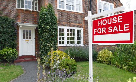 For sale sign outside a house in an affluent suburb of Londonの写真素材