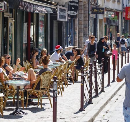Lille, France - July 20, 2013. Women tourists sit at tables on the pavement outside a typical French cafe in the historic city centre of Lille, Franceのeditorial素材