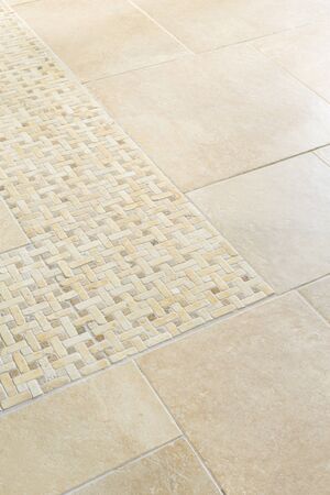 Porcelain floor tiles with a stone mosaic design in a neutral cream colourの写真素材