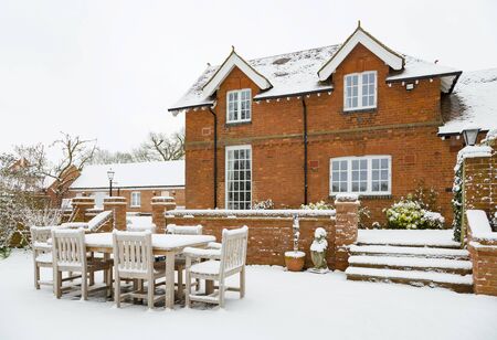 House and patio in snow in winter in England, UKの写真素材