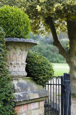 English garden with a Victorian stone urn. England, UKの写真素材