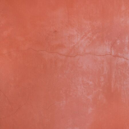 Vintage retro wall detail with cracked and distressed paint on a rendered wall in Venice, Italy