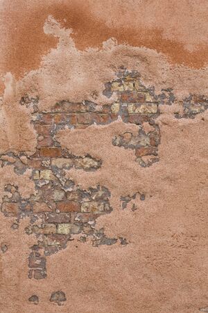 Detail of a distressed and weathered brick wall in Venice, Italy. Ideal as a retro or vintage background or textureの写真素材