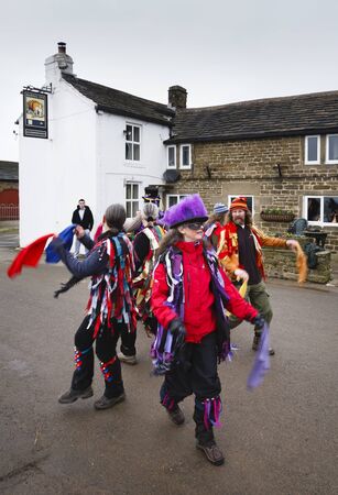 PEAK DISTRICT, UK - January 29, 2012. Morris dancers perform a traditional pagan dance outside the Barrel Inn in Derbyshire, UK.のeditorial素材