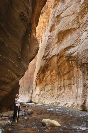 Asian Indian woman canyoneering in the Narrows, Zion National Park, Utahの写真素材