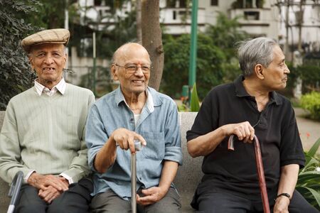 BENGALURU, INDIA - June 25, 2010. Happy old Indian men relax on a park bench in Bangalore, Indiaのeditorial素材