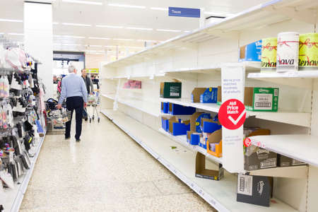 BUCKINGHAM, UK - March 16, 2020. Tesco supermarket shoppers looking at empty shelves due to the...
