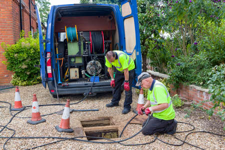 BUCKINGHAM, UK - August 07, 2015. Drain cleaning company unblocking sewage drain by jetting, UK