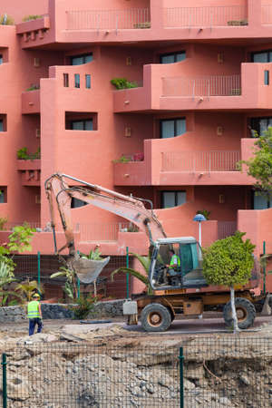 TENERIFE, CANARY ISLANDS - May 17, 2018. Bulldozer digging, building work making noise and ruining...