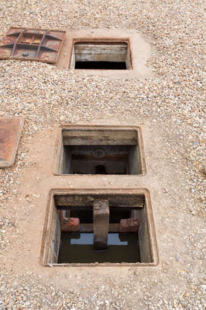 Inspecting an underground septic or rainwater harvesting tank with open inspection chamber, UKの写真素材
