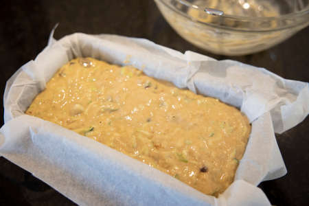 Courgette zucchini loaf cake mixture in a tin (before baking)の写真素材