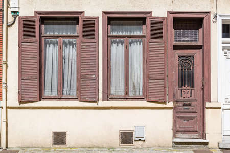 LILLE, FRANCE - July 19, 2013. Outside an old French house with wooden doors and windows with shutters painted brownのeditorial素材