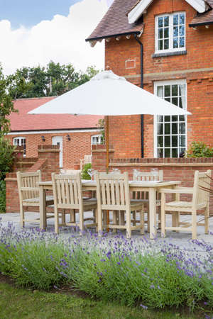 Large UK house with garden furniture in a back garden with patio terraceの写真素材