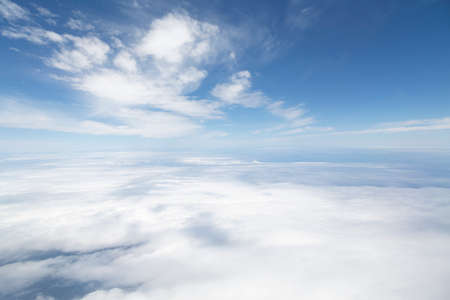 Aerial view flying above clouds. Depicts heaven and Earth concept and the environmentの写真素材