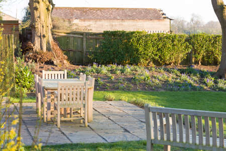 Garden patio furniture in wintertime, a large back garden in rural Buckinghamshire, UKの写真素材