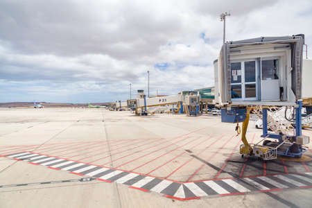 FUERTEVENTURA, SPAIN - May 15, 2013. Empty line of jet bridges, airbridge (passenger boarding bridge or PBB) at Fuerteventura Airport.のeditorial素材
