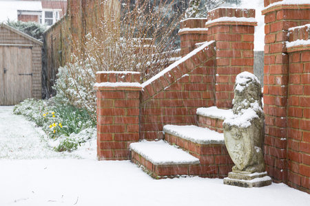 English back garden with terrace and steps covered in snow in winter, UKの写真素材