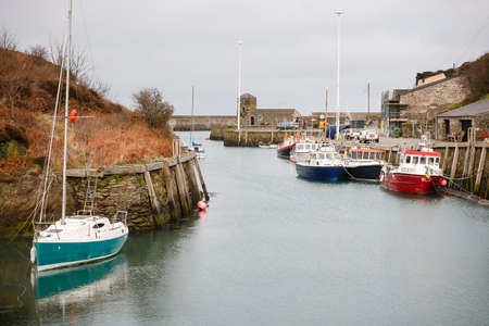 ANGLESEY, UK - February 28, 2012. Yacht and fishing boats in an old harbour, Amlwch Port, Anglesey, Walesのeditorial素材