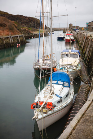 ANGLESEY, UK - February 28, 2012. Sailing boats, yachts in an ancient harbour on the Welsh coast. Amlwch Port, Anglesey, North Walesのeditorial素材