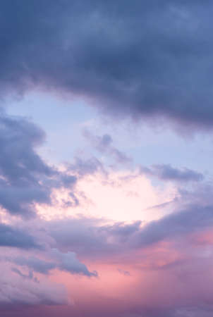 Dramatic sky at sunset with moody storm clouds before a thunder storm. Ideal for a background or templateの写真素材