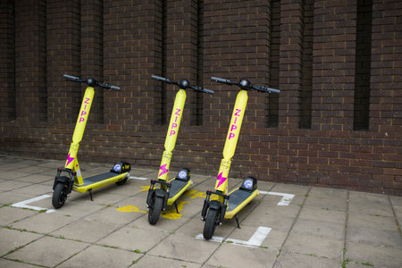AYLESBURY, UK - July 01, 2021. Rental electric scooters (e-scooter) parked on a pavement in a UK town.のeditorial素材
