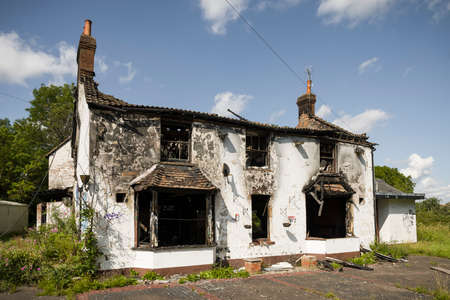 BUCKINGHAMSHIRE, UK - August 10, 2021. Fire damaged house. Building with burnt down roof and blackened walls.のeditorial素材