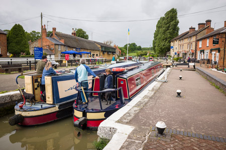 NORTHAMPTONSHIRE, UK - May 25, 2022. Narrowboats or canal barges in a lock on the Grand Union Canal at Stoke Bruerne villageのeditorial素材