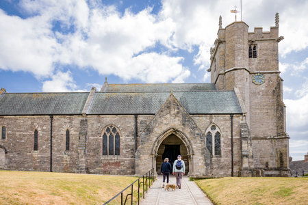 DORSET, UK - July 06, 2022. Couple visiting Saint Edward parish church in Corfe Castle, Dorset, UKのeditorial素材