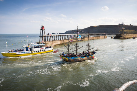 WHITBY, UK - September 21, 2022. Tourists boat trips in Whitby Harbour. Endeavour Experience and Summer Queenのeditorial素材