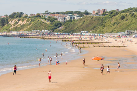 BOURNEMOUTH, UK - July 08, 2022. Man jogging on the beach in summer. Bournemouth, Dorset, UK