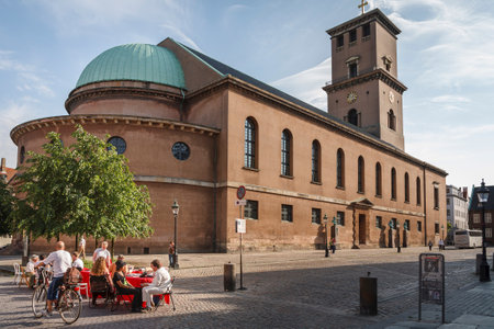 COPENHAGEN, DENMARK - June 17, 2006. Group of people sitting at a table in Frue Plads Square outside the Church of Our Lady, Copenhagen, Denmarkのeditorial素材
