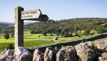 Wooden public footpath sign for Dales Way in Wharfedale countryside. Grassington, Yorkshire Dales, UKの写真素材