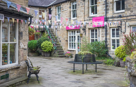 Pateley Bridge, UK - September 15, 2024. Old buildings with shops in Kings Court, Pateley Bridge,...