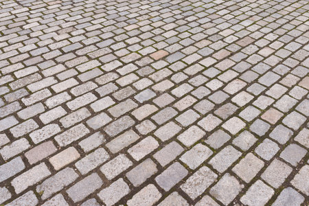 Vintage grey tumbled paving blocks in a UK street. Full frame background, texture or patternの写真素材