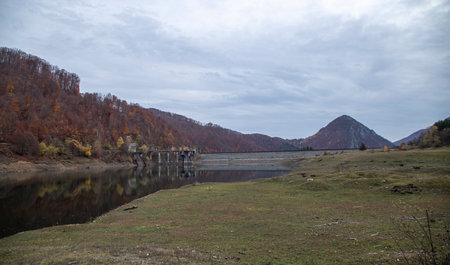 Valea Mare, Gorj, Romania â November 04, 2021: The Great Valley ( Valea Mare ) Dam is reflected in the accumulation lake.のeditorial素材