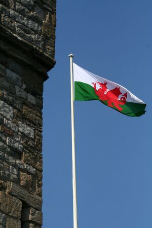 Welsh flag flying next to a castleの写真素材