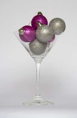 Purple and silver Christmas baubles in a cocktail glassの写真素材