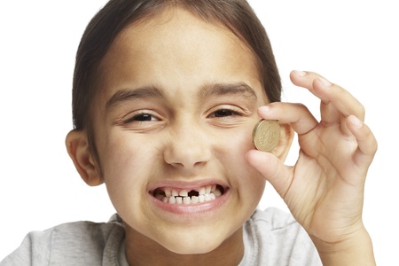 Young girl with missing front tooth on white backgroundの写真素材
